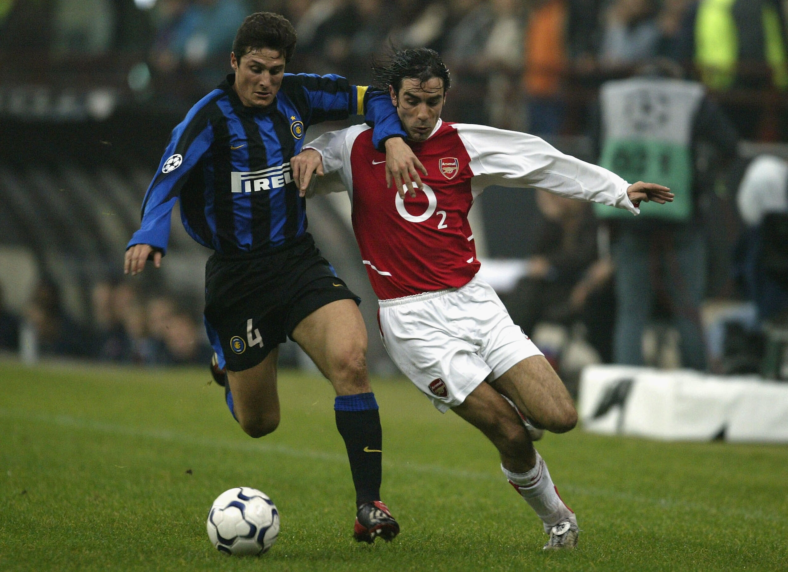 Robert Pires of Arsenal battles with Javier Zanetti of Inter